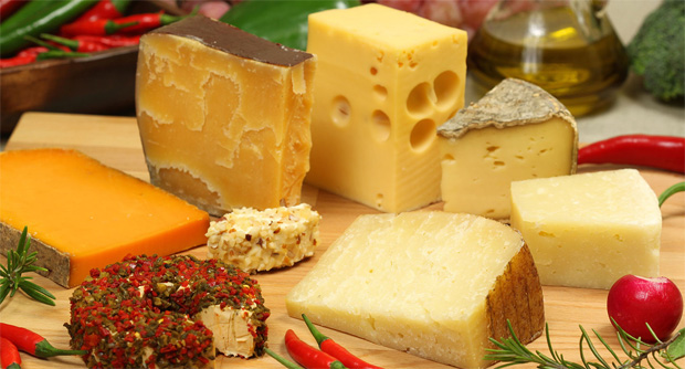 На столе большое разнообразие сыров разных видов и сортов